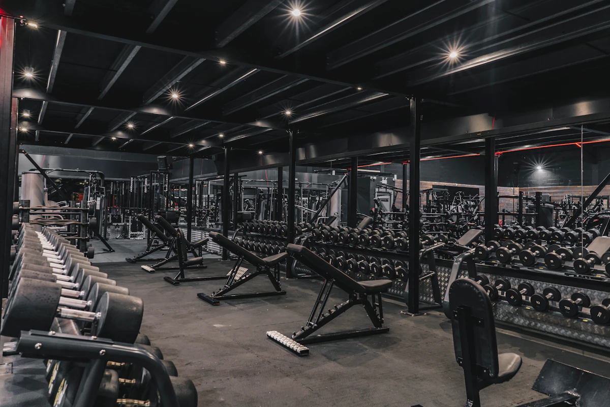A gym floor lined with machines, racks and free weights
