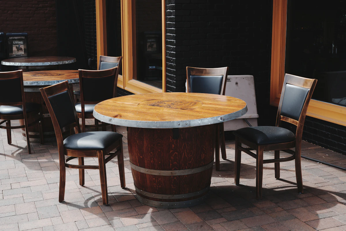 Outdoor tables and chairs set on a brick restaurant patio