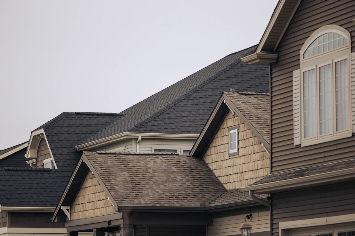 Crisp new shingle lines across a row of suburban rooftops