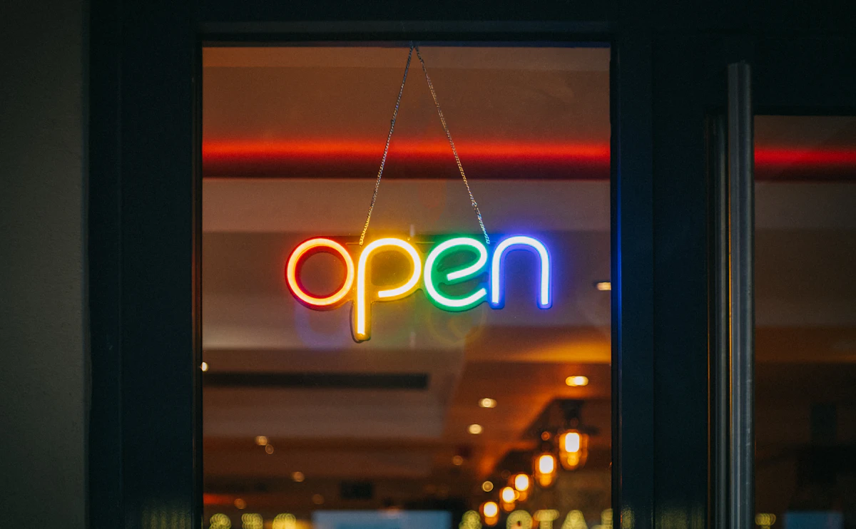 A neon OPEN sign glowing in the clinic window after dark